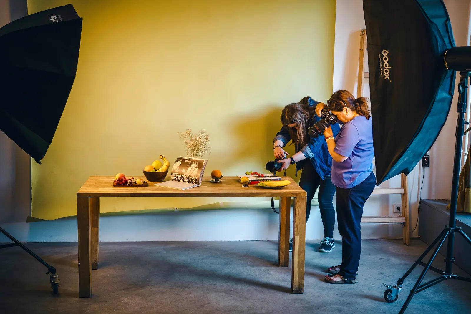 Two photographers working on a food shoot in a Berlin studio with professional lighting