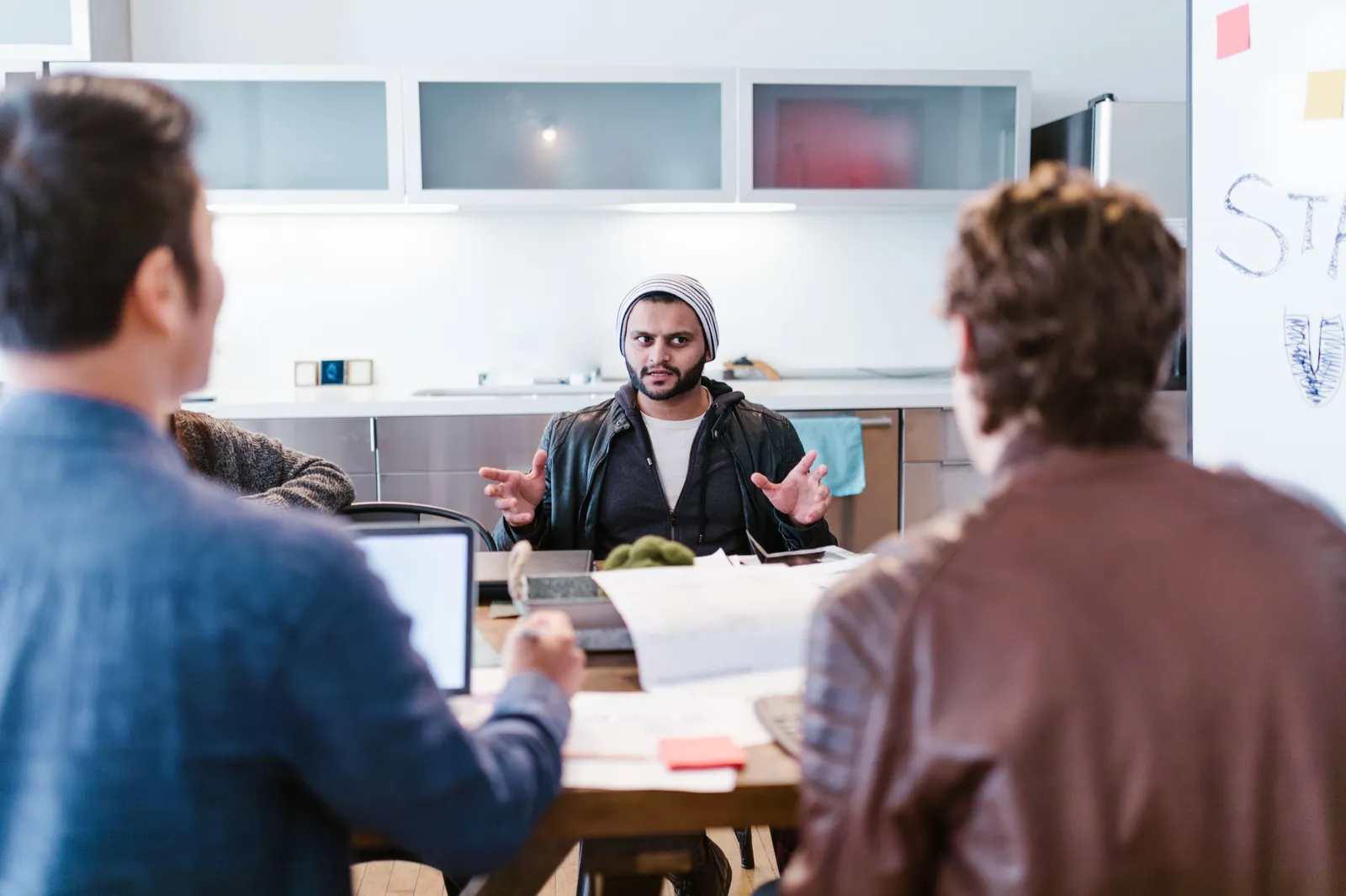 A diverse team gathers for a creative strategy meeting in a modern office setting