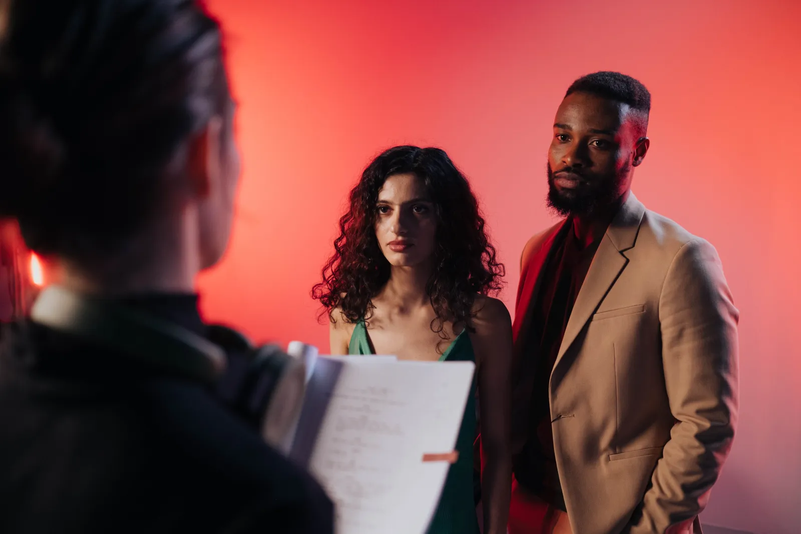 Couple reading script in a studio with warm lighting for film or theater production