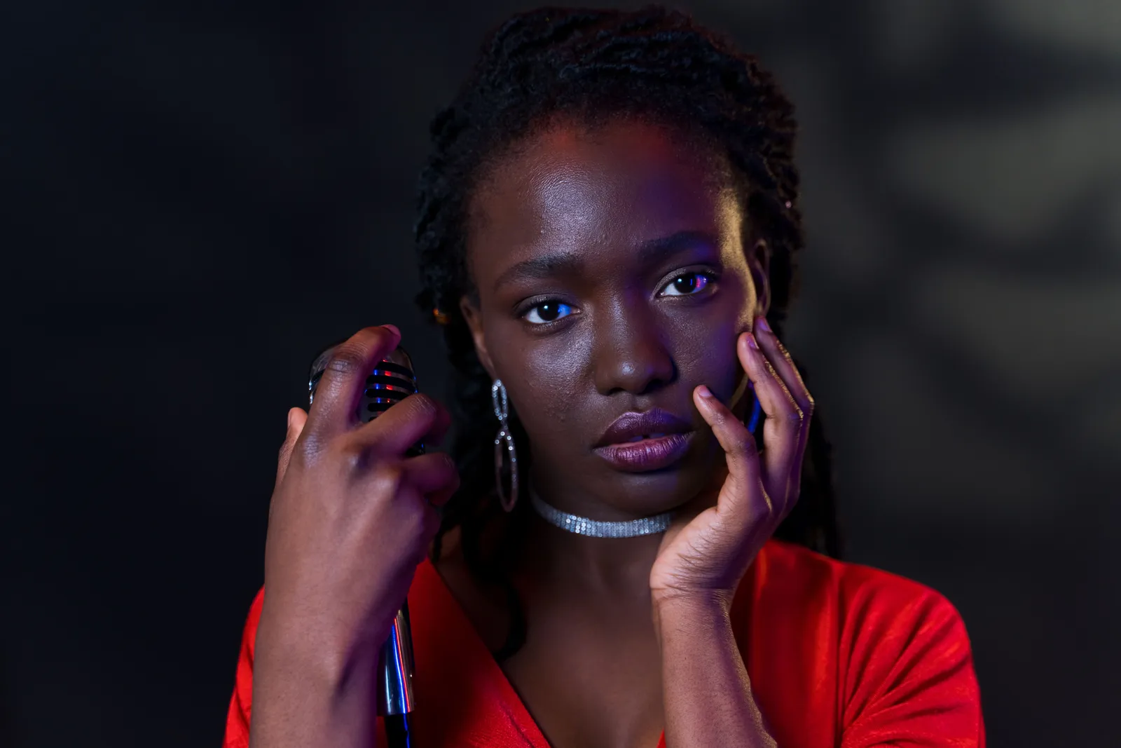 A captivating portrait of a confident woman holding a microphone. Perfect for music themes