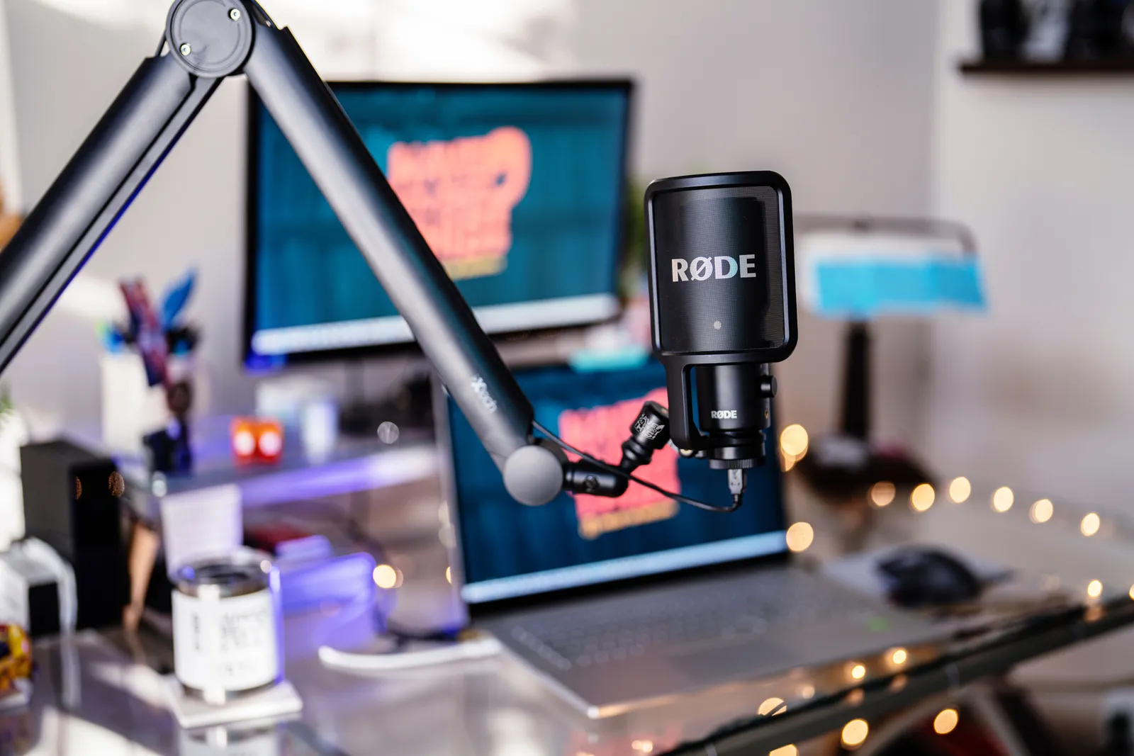 Close-up of a modern podcast studio featuring a RØDE microphone and digital workspace, ideal for content creators