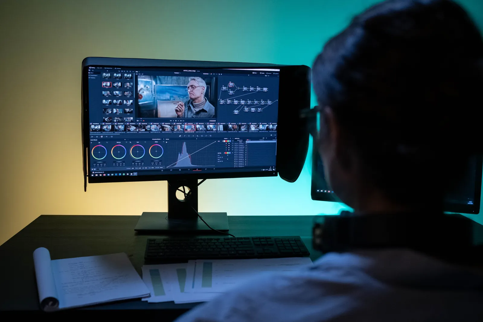 Woman working remotely on video editing in a dimly lit room