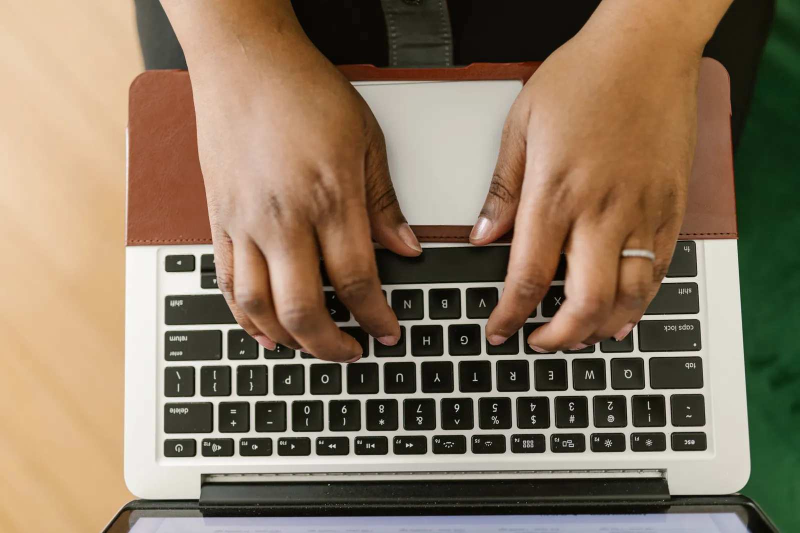 Close-up of hands typing on a laptop keyboard, showcasing productivity and technology