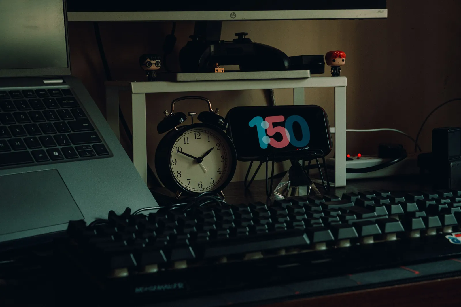 A modern workspace featuring a laptop, analog clock, and creative desk decor for a productive home office setup