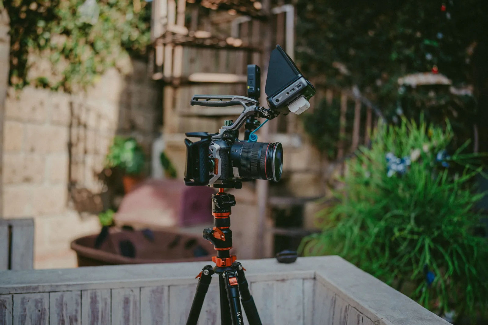 A high-quality camera setup on a tripod outdoors, ideal for professional filming and photography