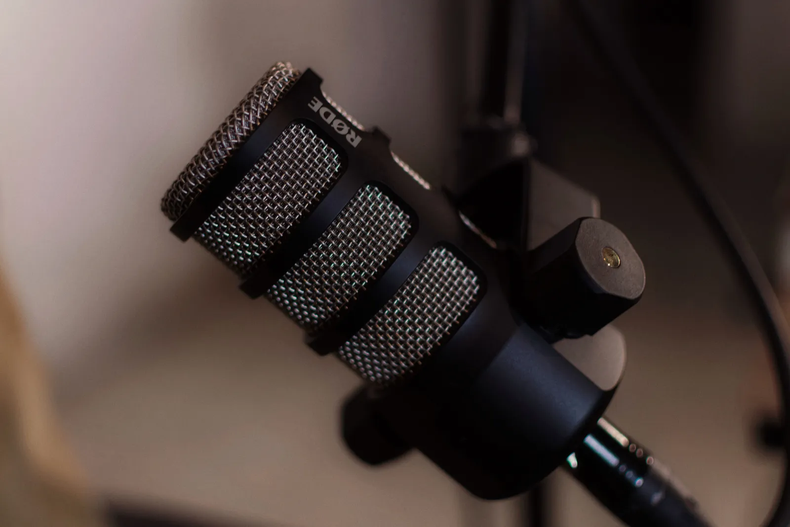 Detailed close-up of a RODE microphone in a professional studio environment, ideal for audio recording
