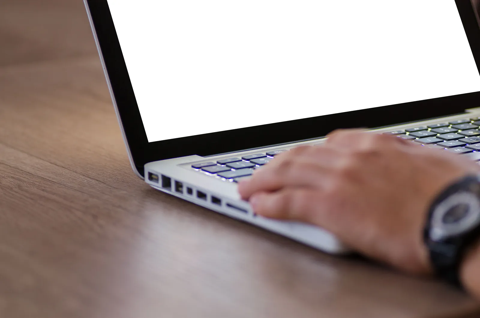 Close-up of a hand using a laptop with a blank screen, ideal for adding custom content