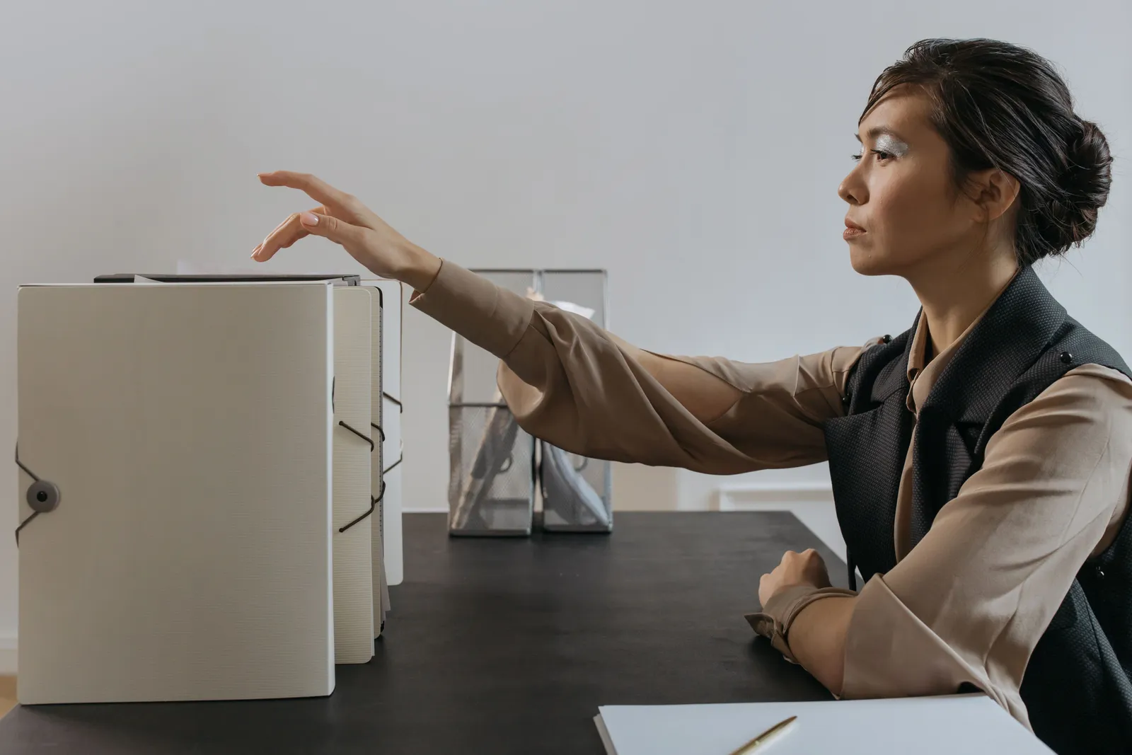 Woman efficiently organizing documents at an office desk