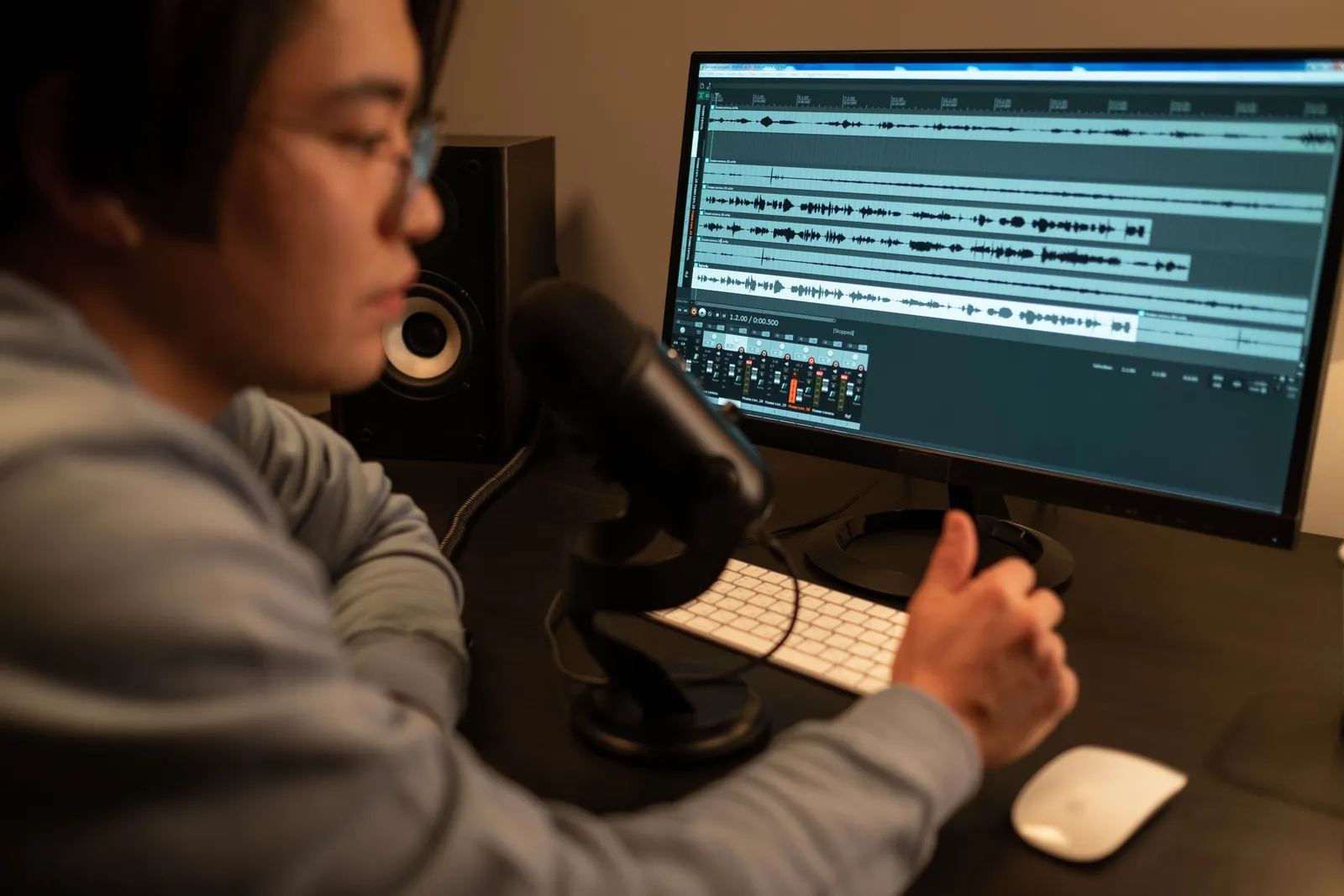Sound engineer working on audio editing with a computer in a recording studio
