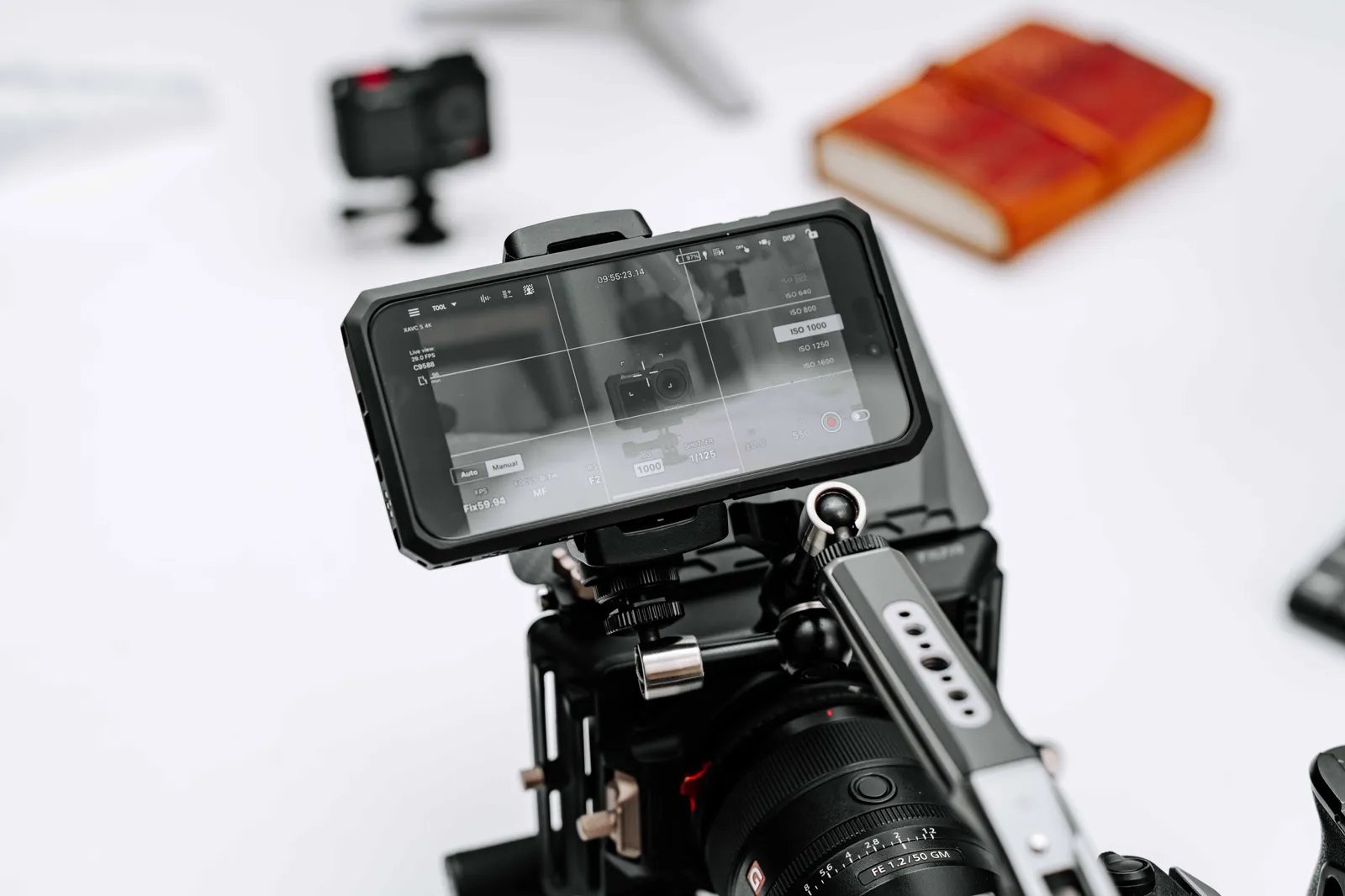 Close-up of a professional camera rig with monitor display in a studio setting, ideal for filmmaking