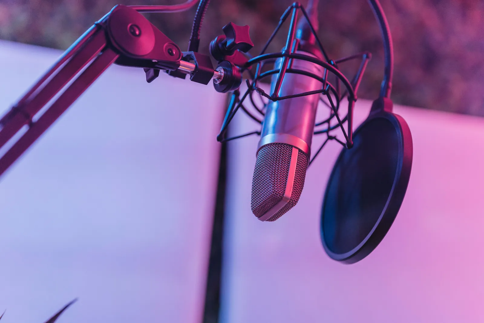A close-up view of a microphone in a vibrant studio environment, ideal for podcasts and voice recording