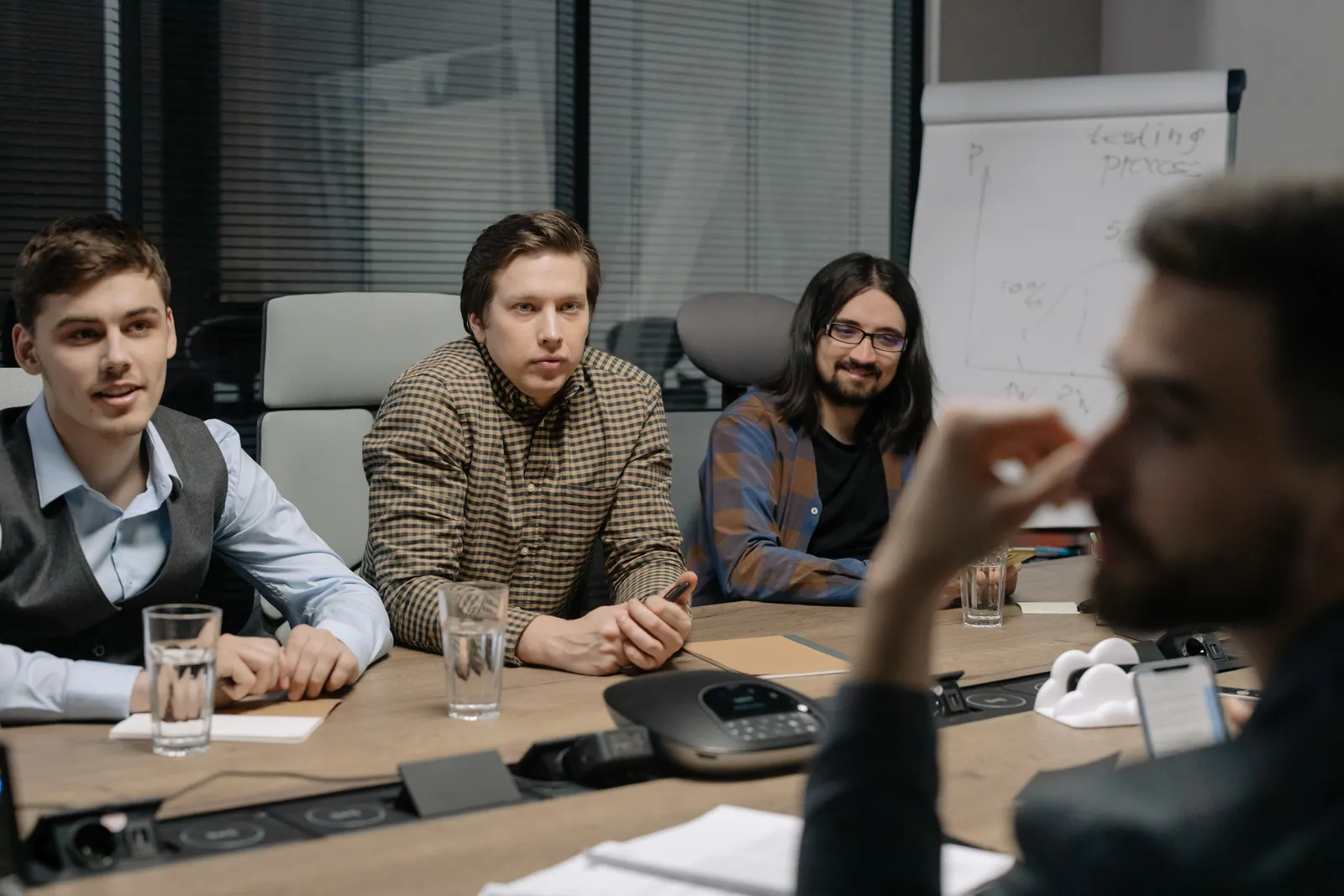 Professional team engaged in a business meeting at a conference table in a modern office environment