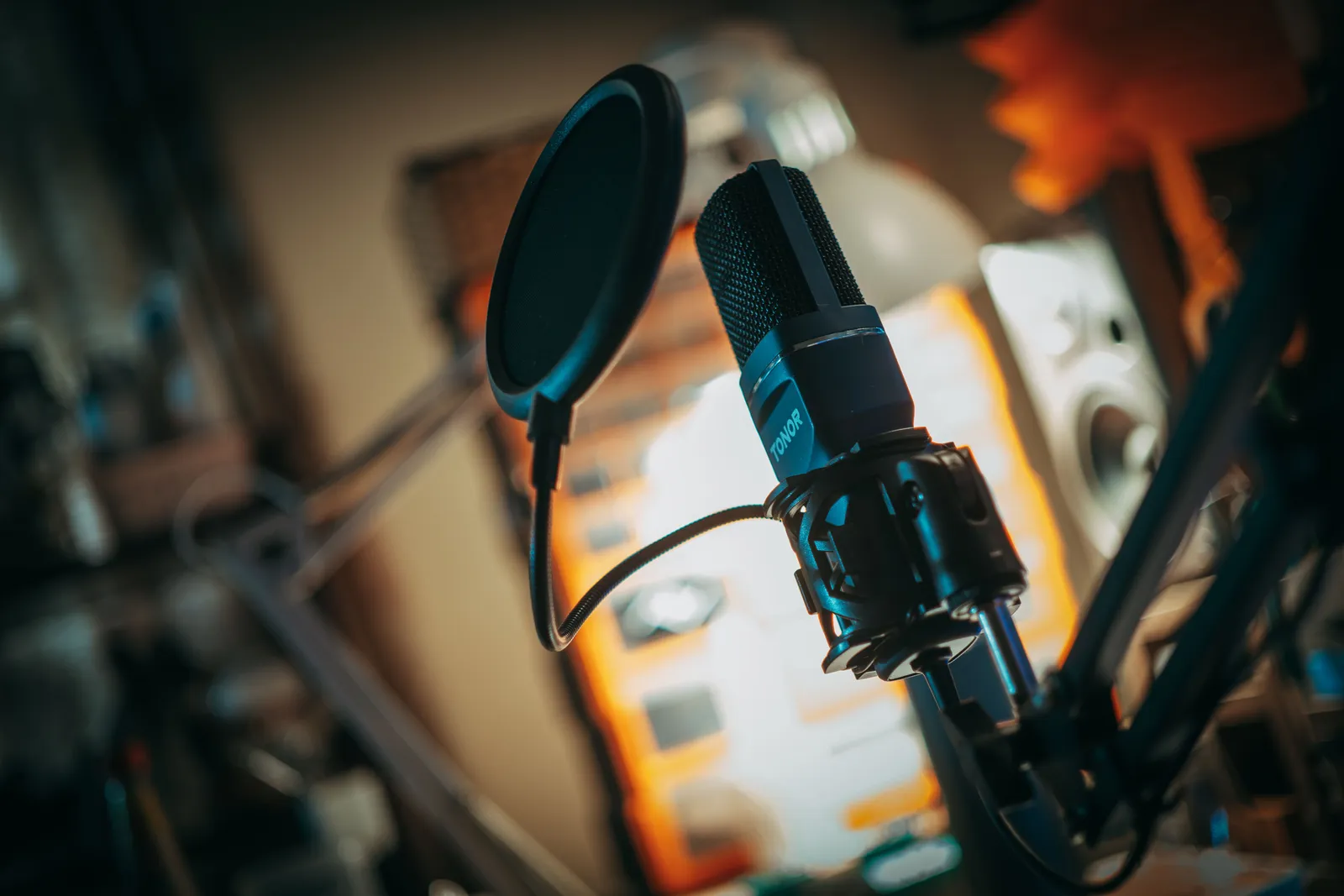Close-up of a microphone with pop filter in a recording studio, perfect for music production visuals