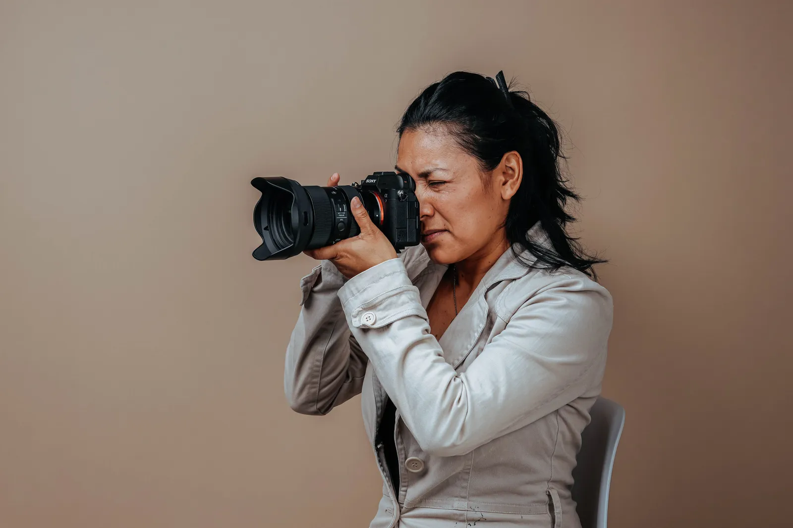 Portrait of a woman in a studio setting using a professional camera