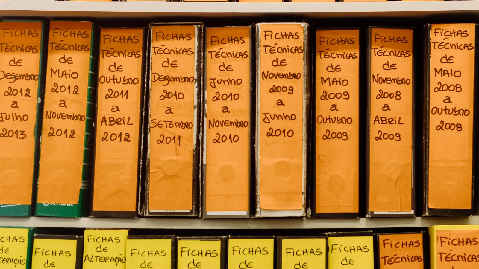 Labeled document binders arranged on office shelves