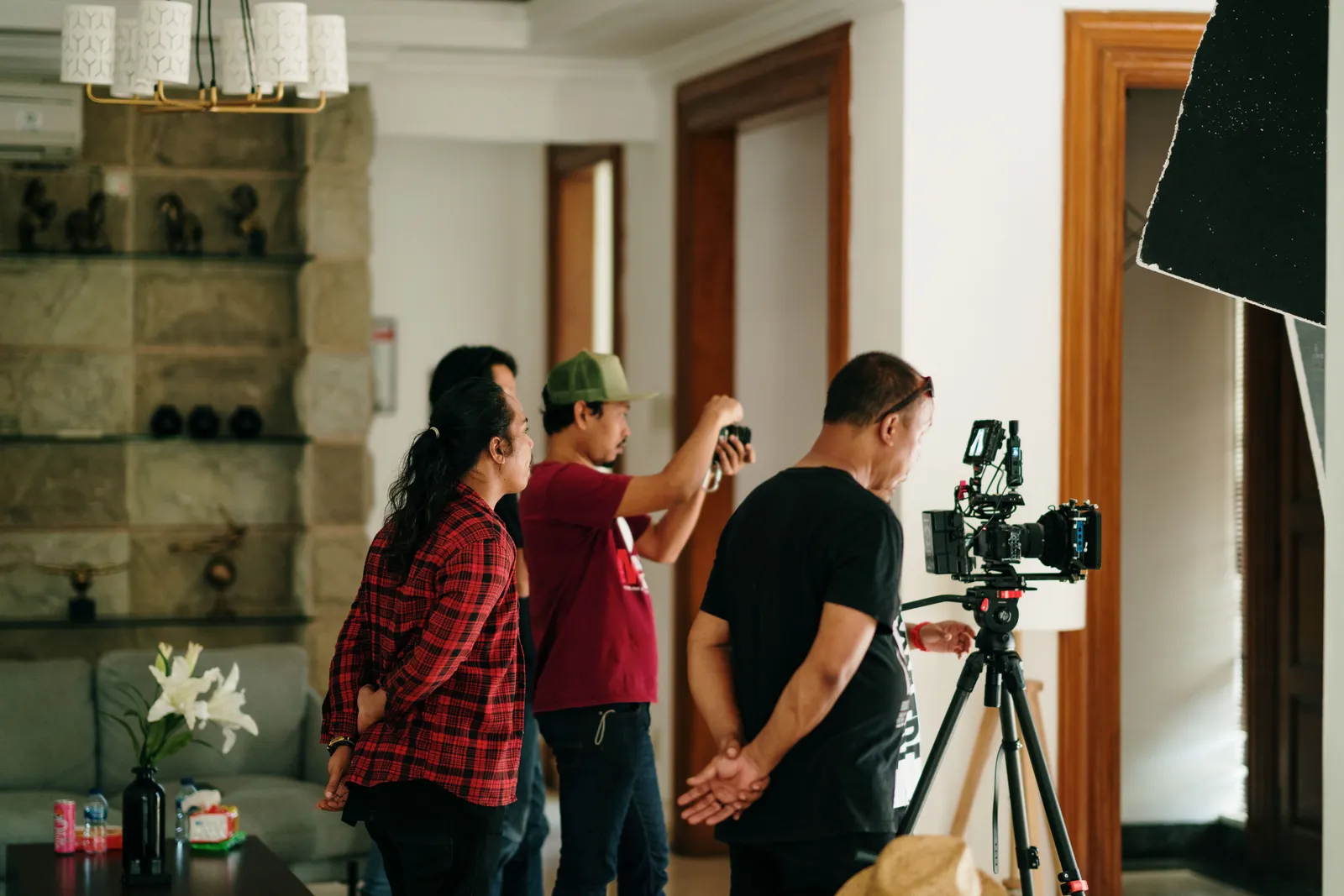 A professional photography crew working inside a studio with camera equipment
