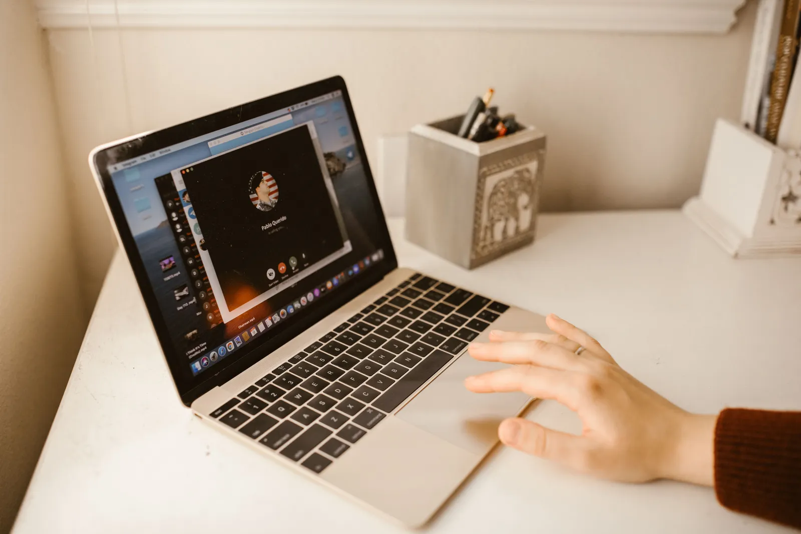 Close-up of a person making a video call on a laptop, showcasing modern communication technology